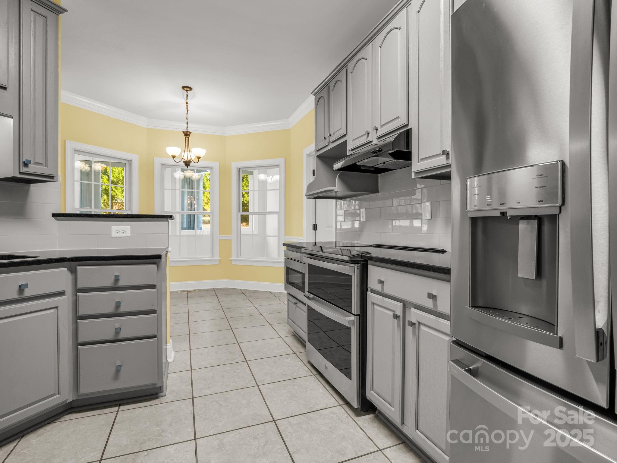 757 Smith Grove Road Forest City, NC 28043 - Photo 13 of 46 a kitchen with granite countertop a stove cabinets and stainless steel appliances