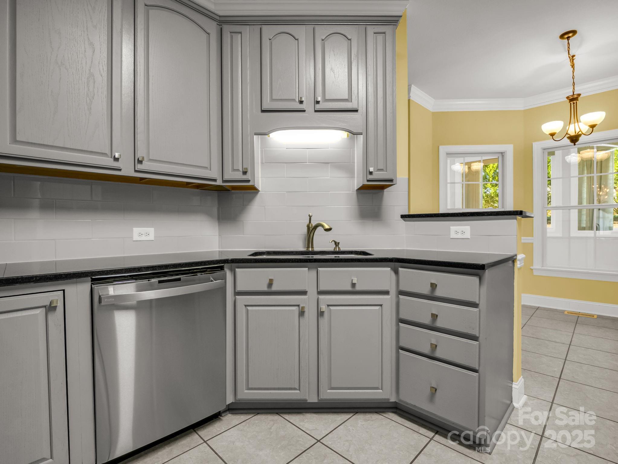 757 Smith Grove Road Forest City, NC 28043 - Photo 14 of 46 a kitchen with granite countertop white cabinets and stainless steel appliances