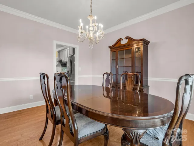a dining room with furniture and chandelier