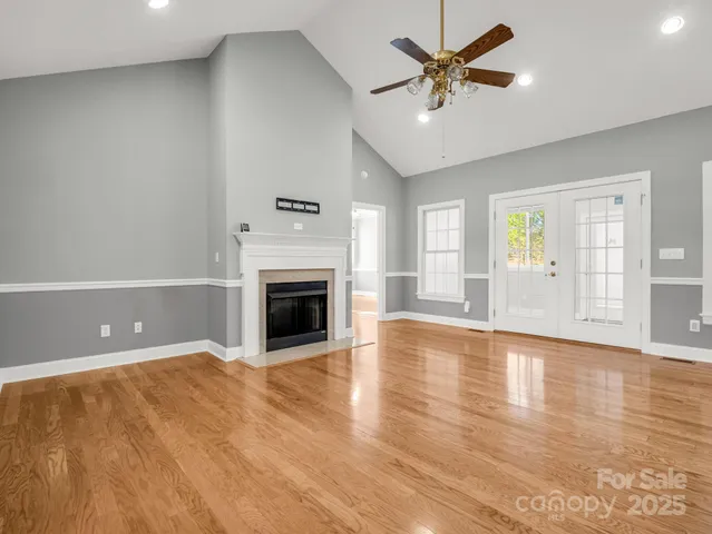 a view of an empty room with a fireplace and a window