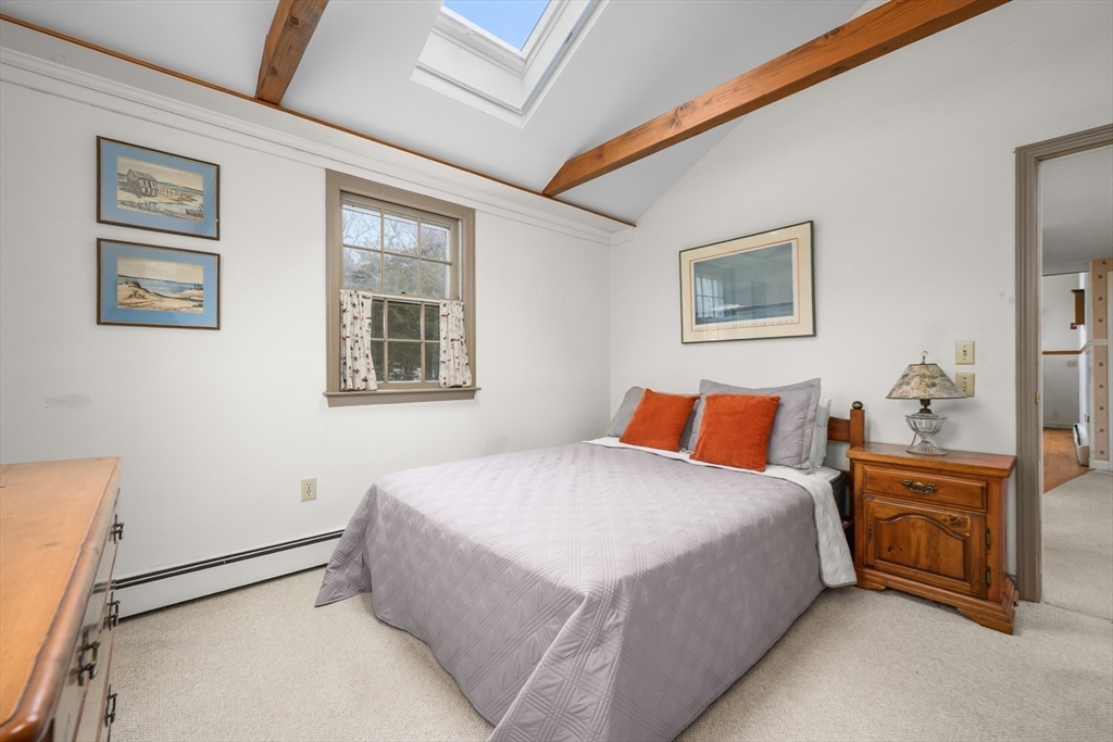 35 Wiley Lane Eastham, MA 02642 - Photo 19 of 38 a bedroom with a bed and a lamp on dresser