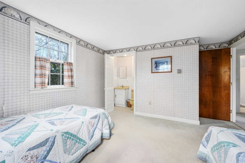 35 Wiley Lane Eastham, MA 02642 - Photo 22 of 38 a spacious bedroom with a bed and a window