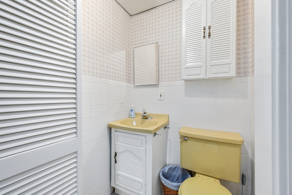 35 Wiley Lane Eastham, MA 02642 - Photo 23 of 38 a bathroom with a sink a toilet and a mirror