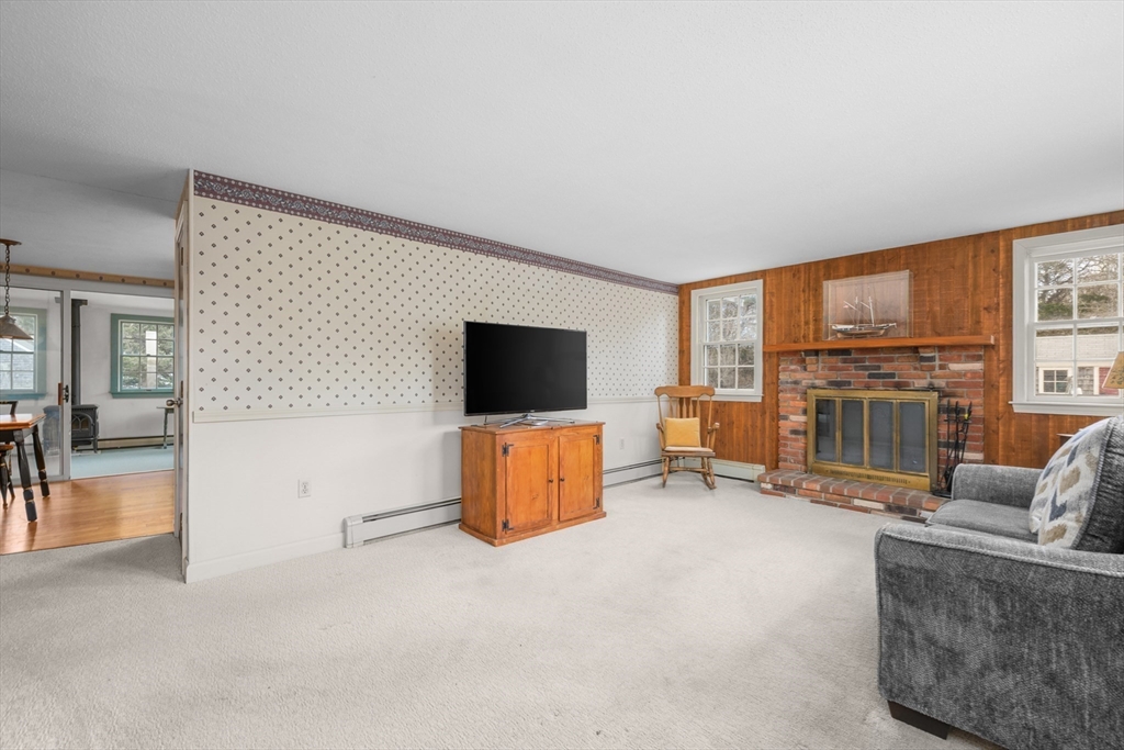 35 Wiley Lane Eastham, MA 02642 - Photo 8 of 38 a living room with furniture and a flat screen tv