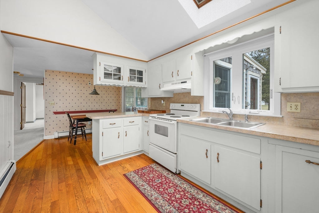 35 Wiley Lane Eastham, MA 02642 - Photo 10 of 38 a kitchen with a sink cabinets and wooden floor
