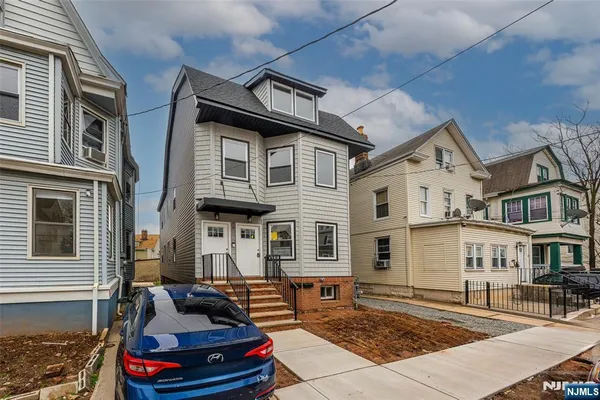 a front view of a house with many windows