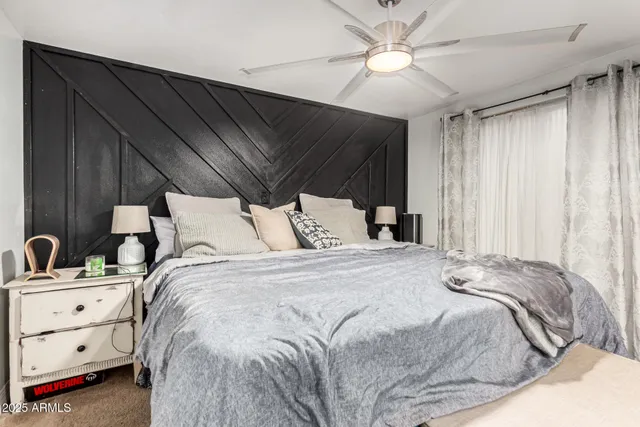 a bedroom with a bed and a window