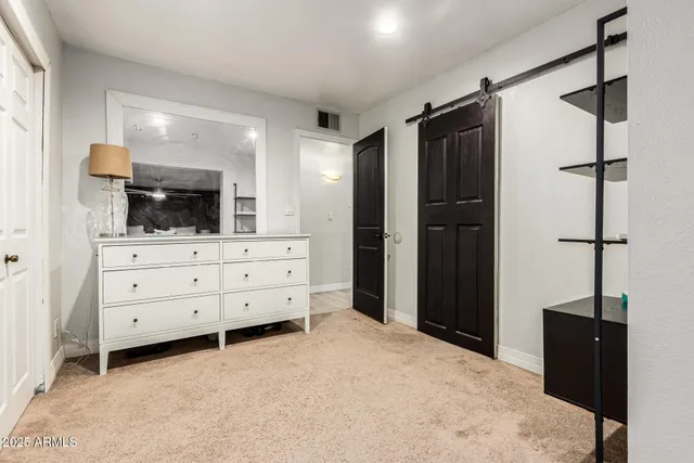 a room with a bed and a television