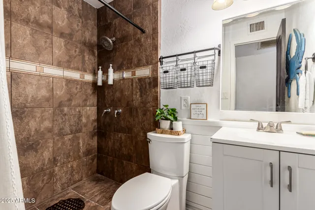 a bathroom with a sink toilet and shower
