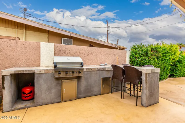 a view of a patio with table and chairs potted plants