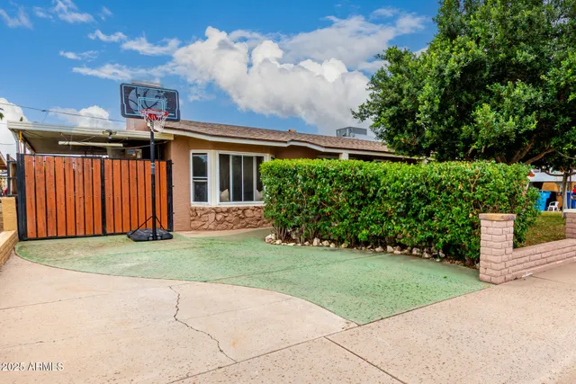 a front view of a house with a garden