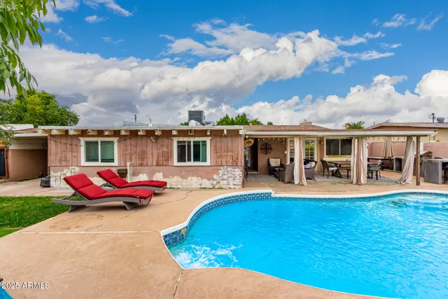 a view of a house with swimming pool and porch