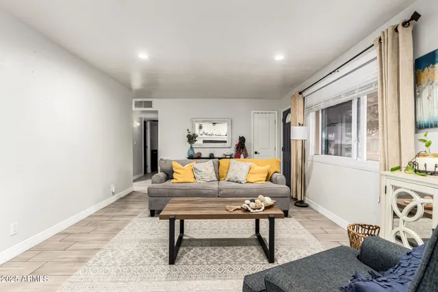 a living room with furniture rug and window