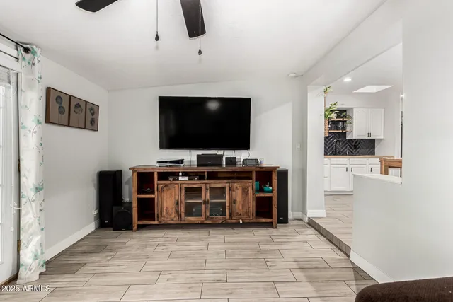 a view of a livingroom with furniture and a flat screen tv