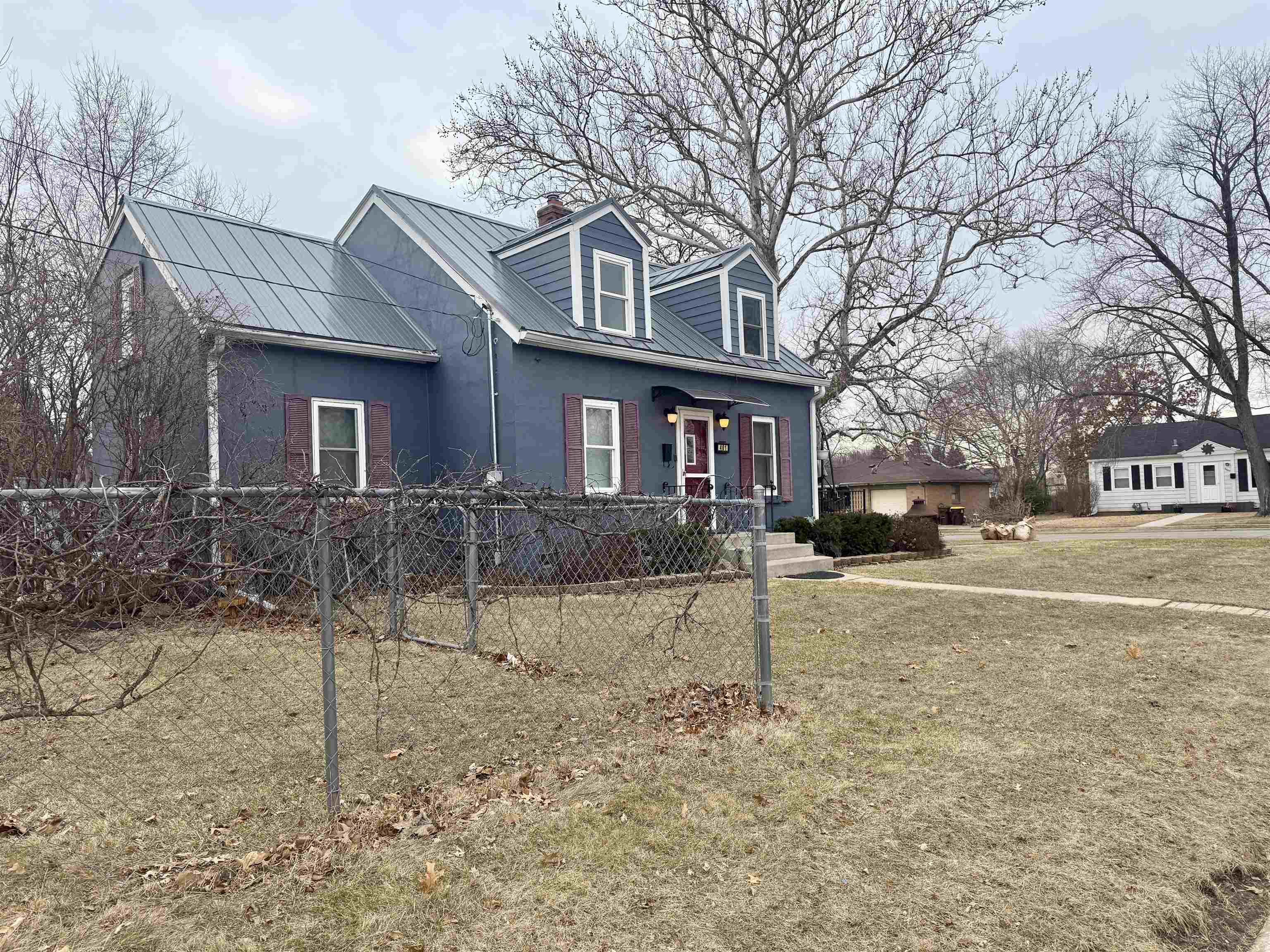 401 Junius Street Loves Park, IL 61111 - Photo 5 of 33 a view of a white house with a yard