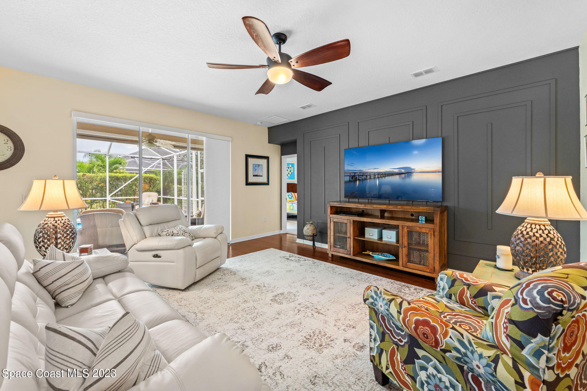 3428 Ahern Place Melbourne, FL 32940 - Photo 16 of 64 a living room with furniture a fireplace and a flat screen tv