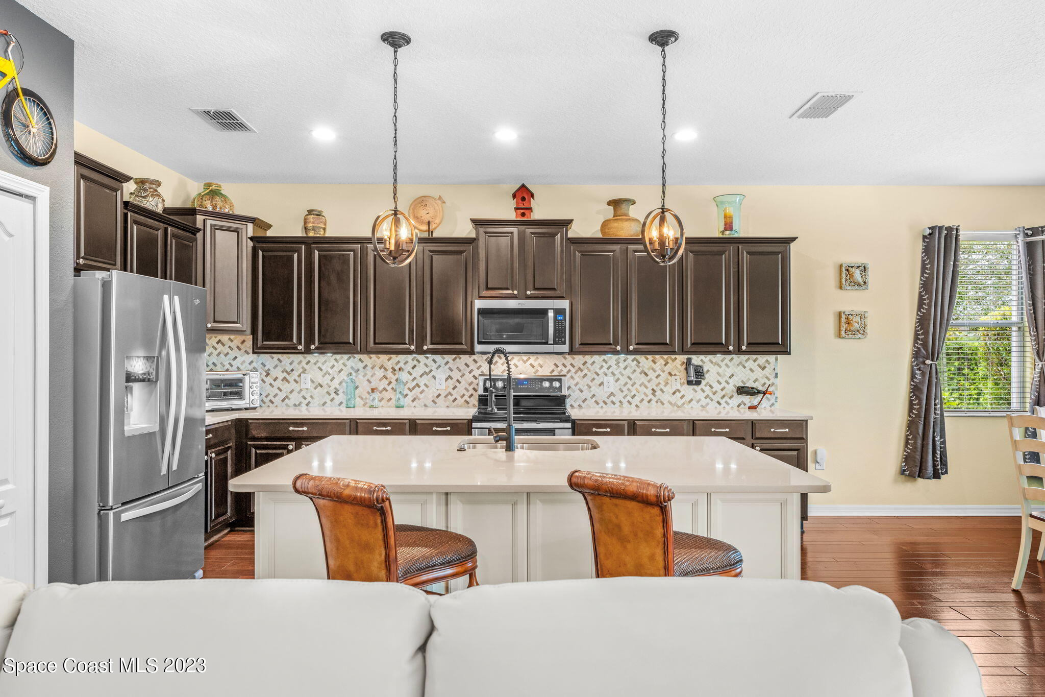 3428 Ahern Place Melbourne, FL 32940 - Photo 19 of 64 a kitchen with stainless steel appliances granite countertop a sink a stove and a refrigerator