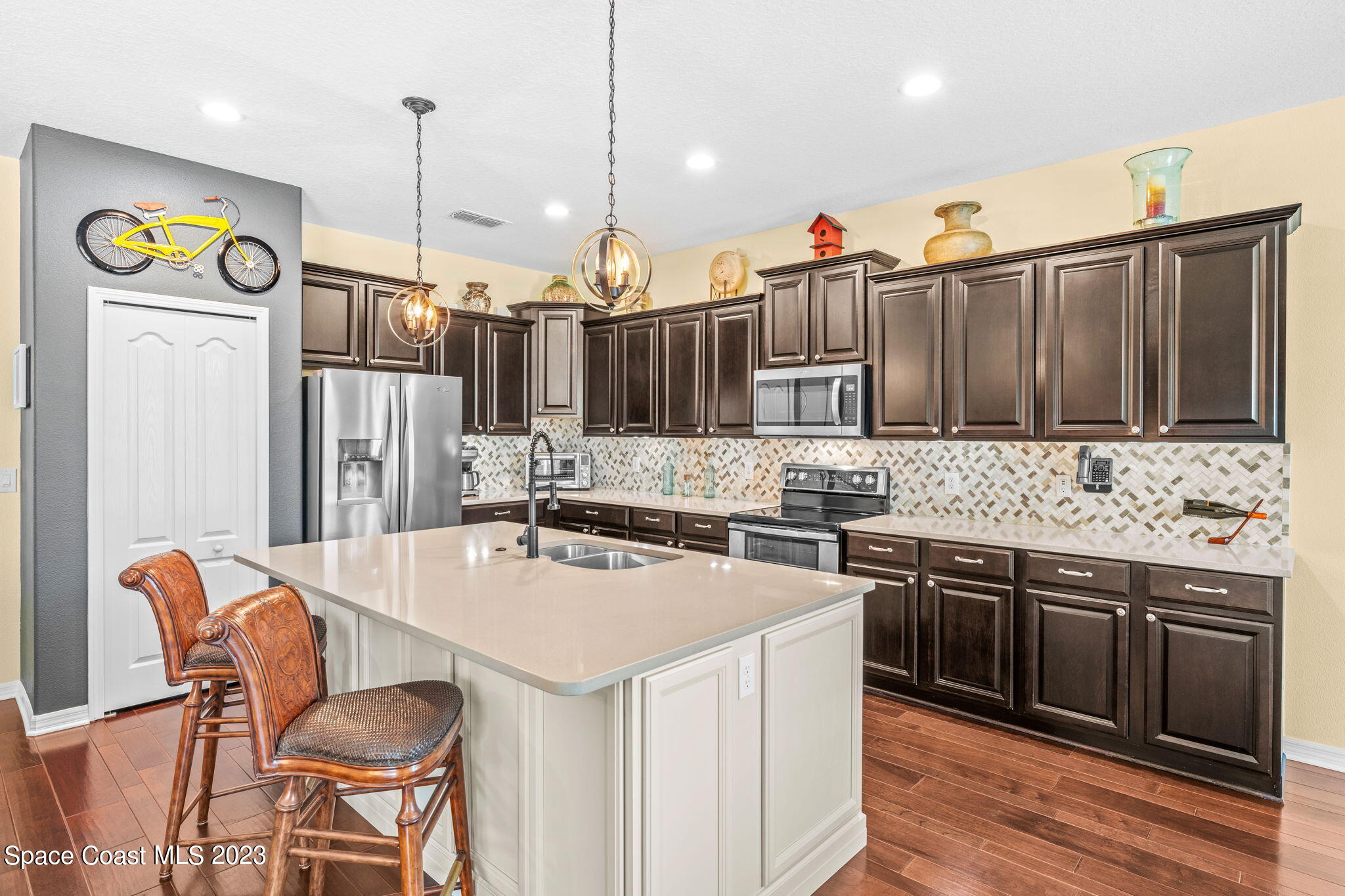 3428 Ahern Place Melbourne, FL 32940 - Photo 20 of 64 a kitchen with stainless steel appliances granite countertop a sink and a refrigerator