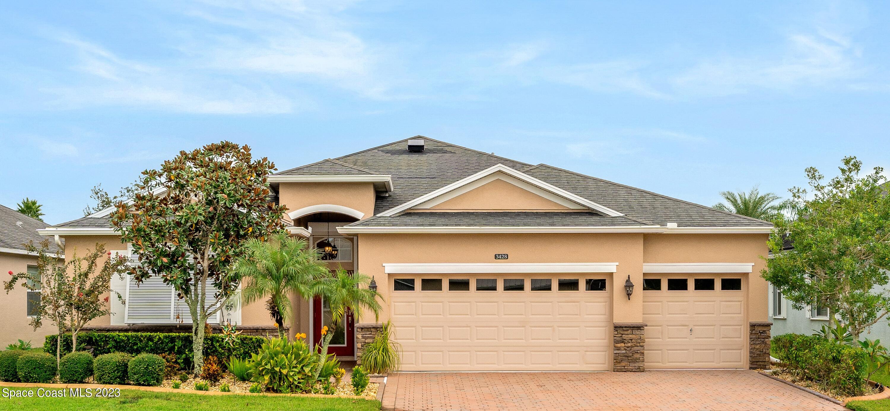 3428 Ahern Place Melbourne, FL 32940 - Photo 2 of 64 a front view of a house with a yard