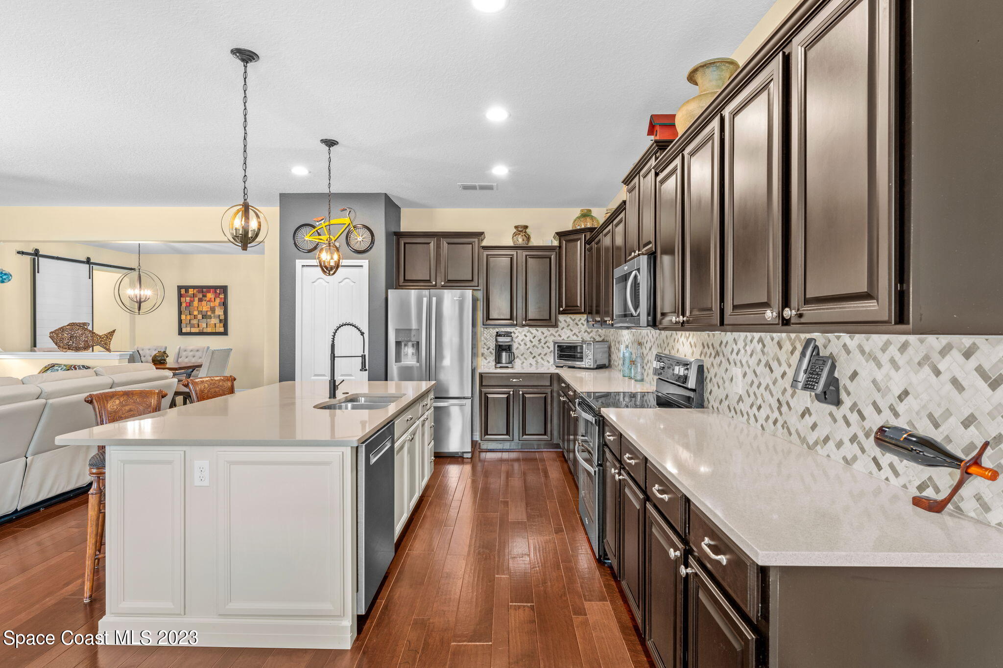3428 Ahern Place Melbourne, FL 32940 - Photo 22 of 64 a kitchen with counter top space sink stove and cabinets