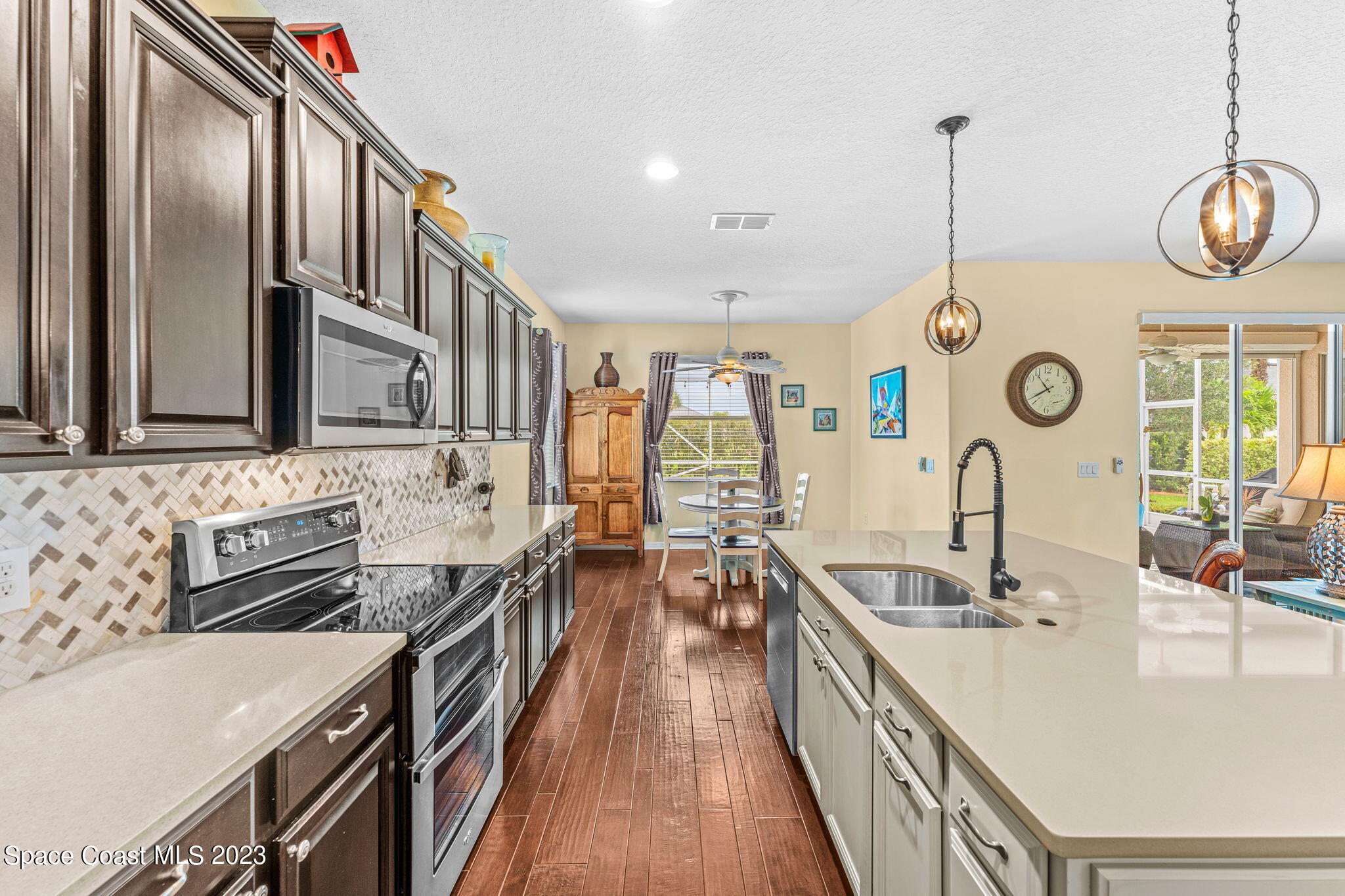 3428 Ahern Place Melbourne, FL 32940 - Photo 25 of 64 a very nice looking kitchen with granite countertop a stove and a sink