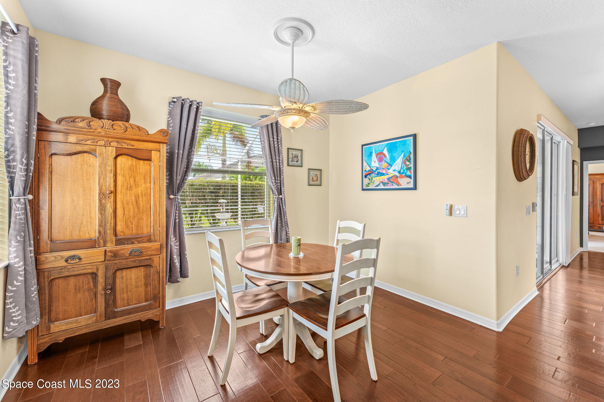 3428 Ahern Place Melbourne, FL 32940 - Photo 26 of 64 a dining room with furniture window wooden floor