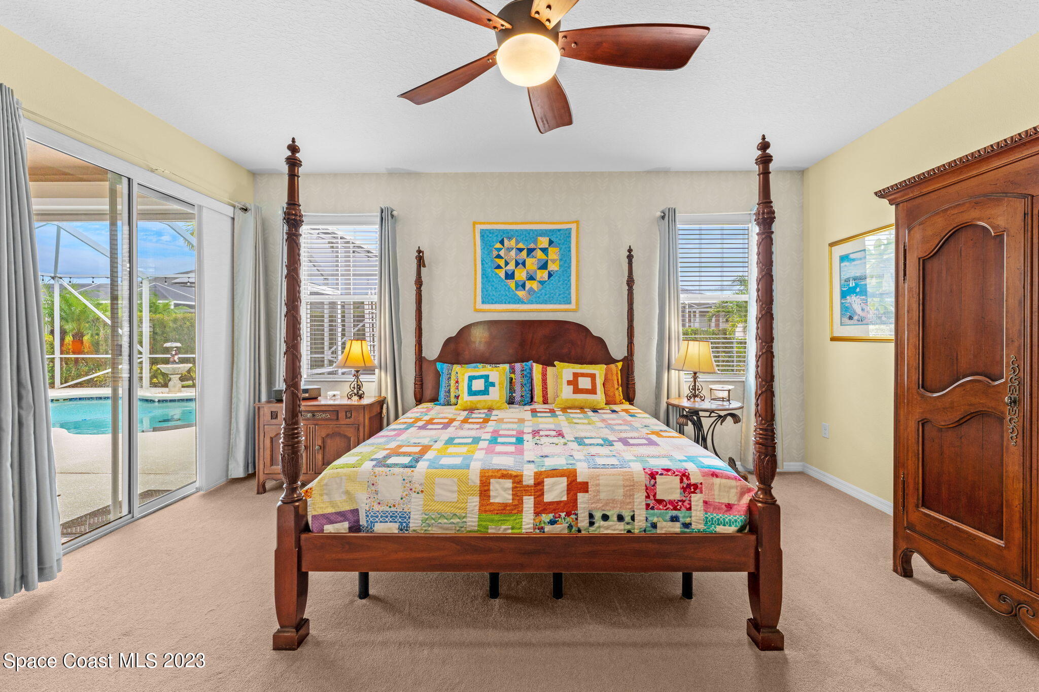 3428 Ahern Place Melbourne, FL 32940 - Photo 28 of 64 a bedroom with a bed and a chandelier