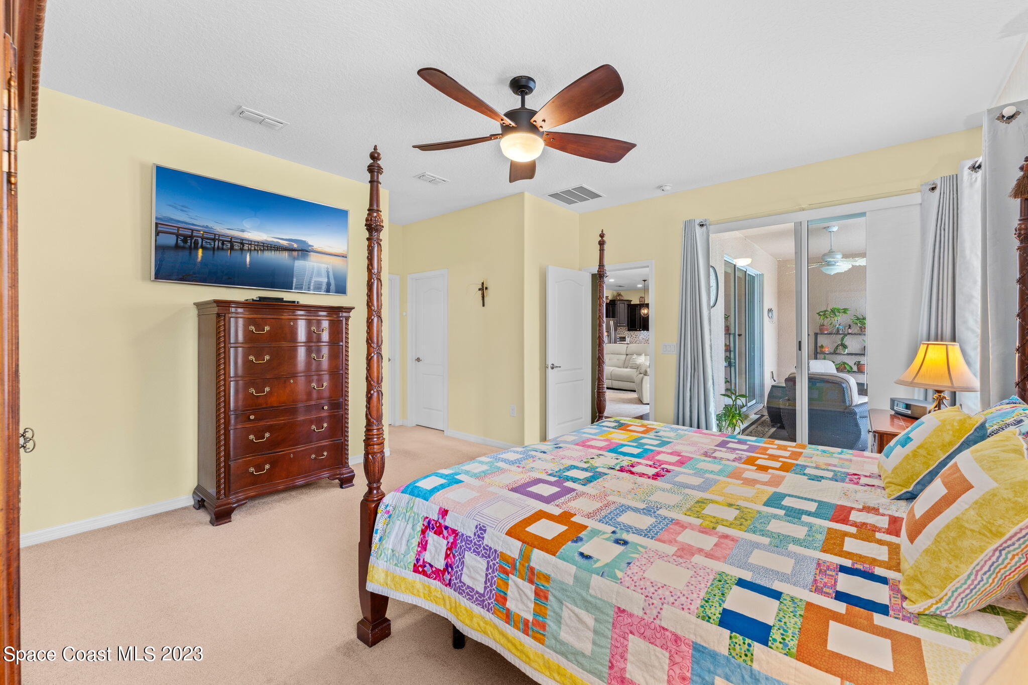 3428 Ahern Place Melbourne, FL 32940 - Photo 29 of 64 a bedroom that has a bed and a chandelier