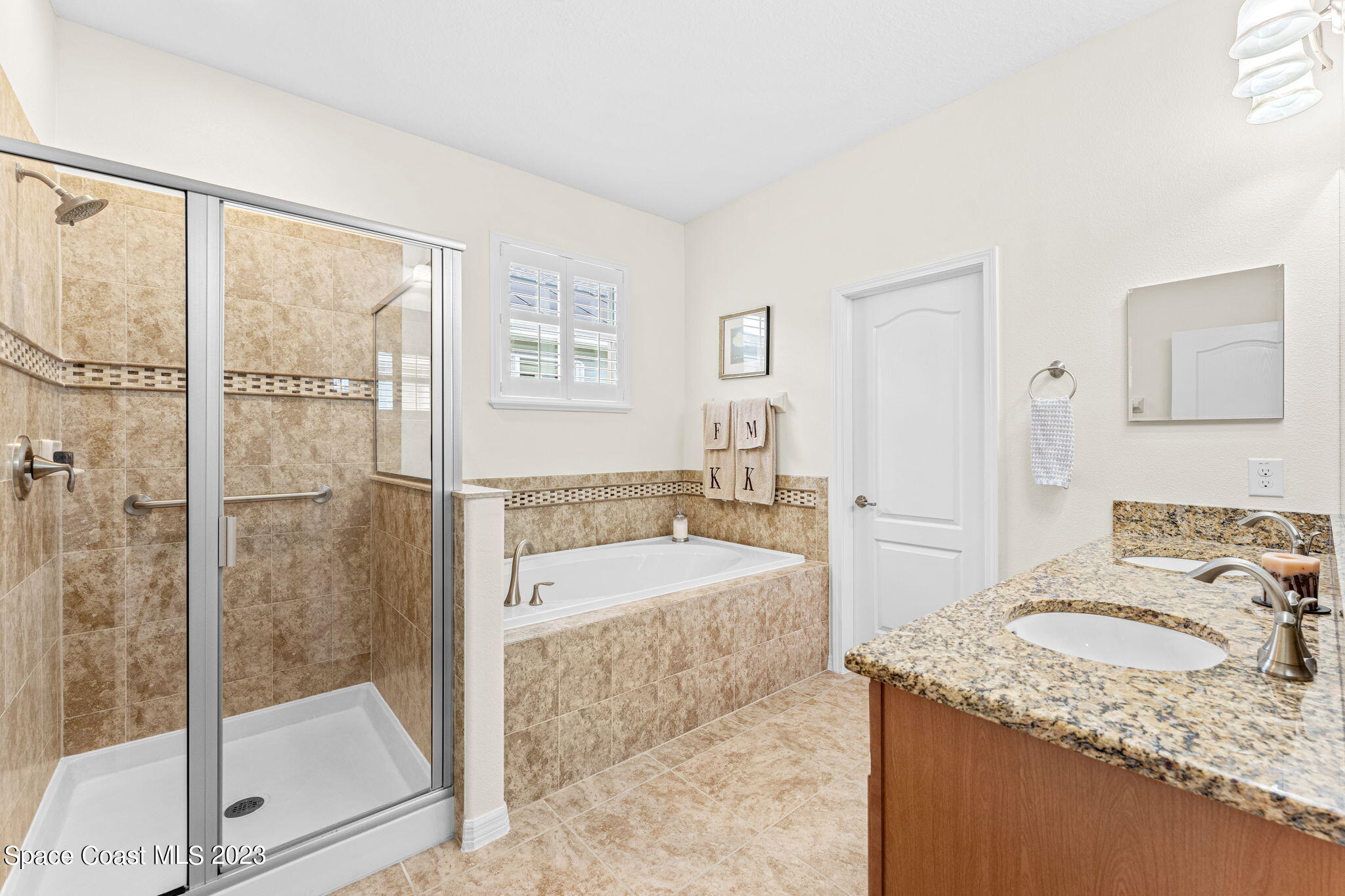 3428 Ahern Place Melbourne, FL 32940 - Photo 30 of 64 a bathroom with a granite countertop sink a mirror and shower
