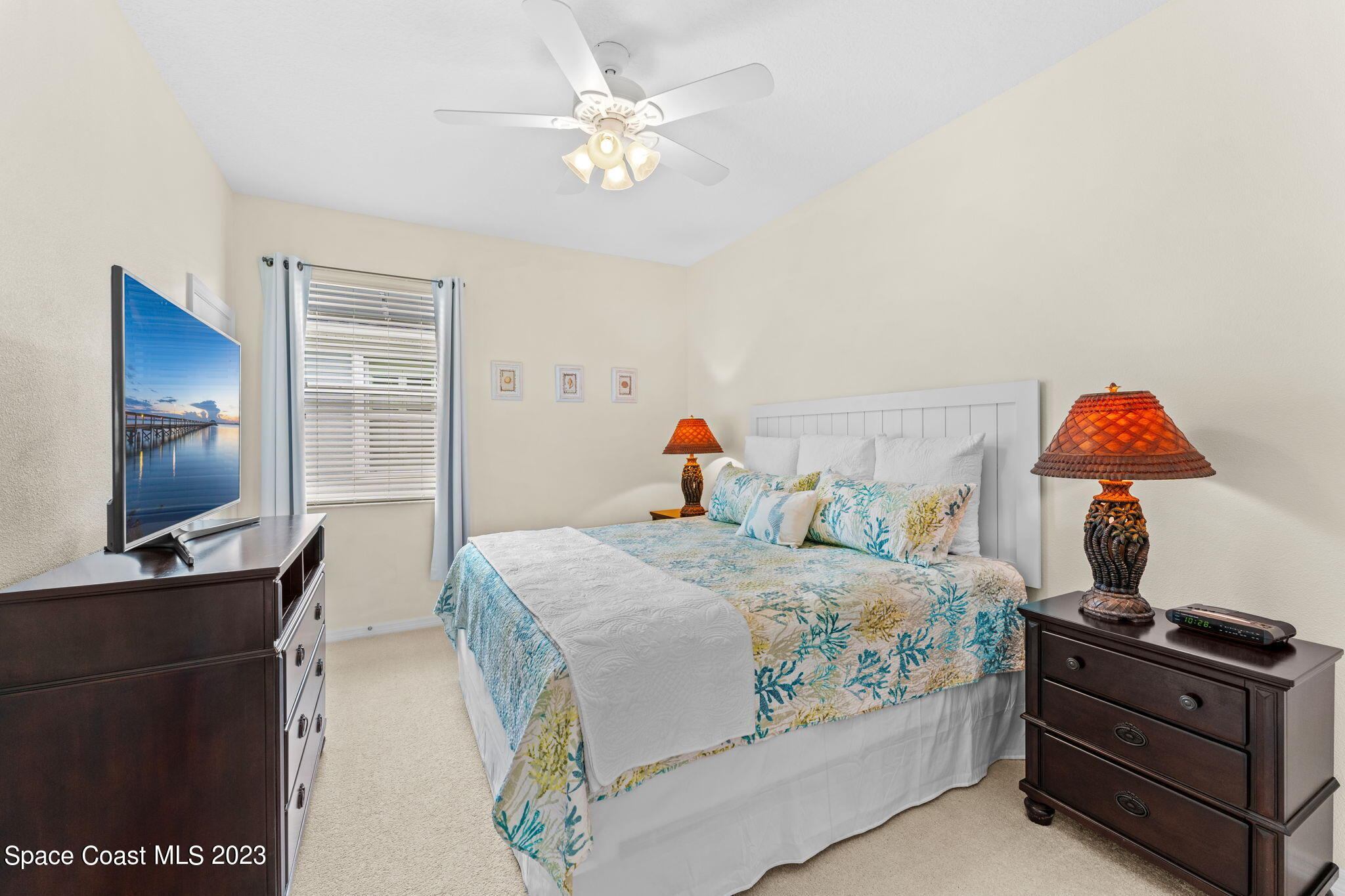 3428 Ahern Place Melbourne, FL 32940 - Photo 33 of 64 a bedroom with a bed and a flat screen tv