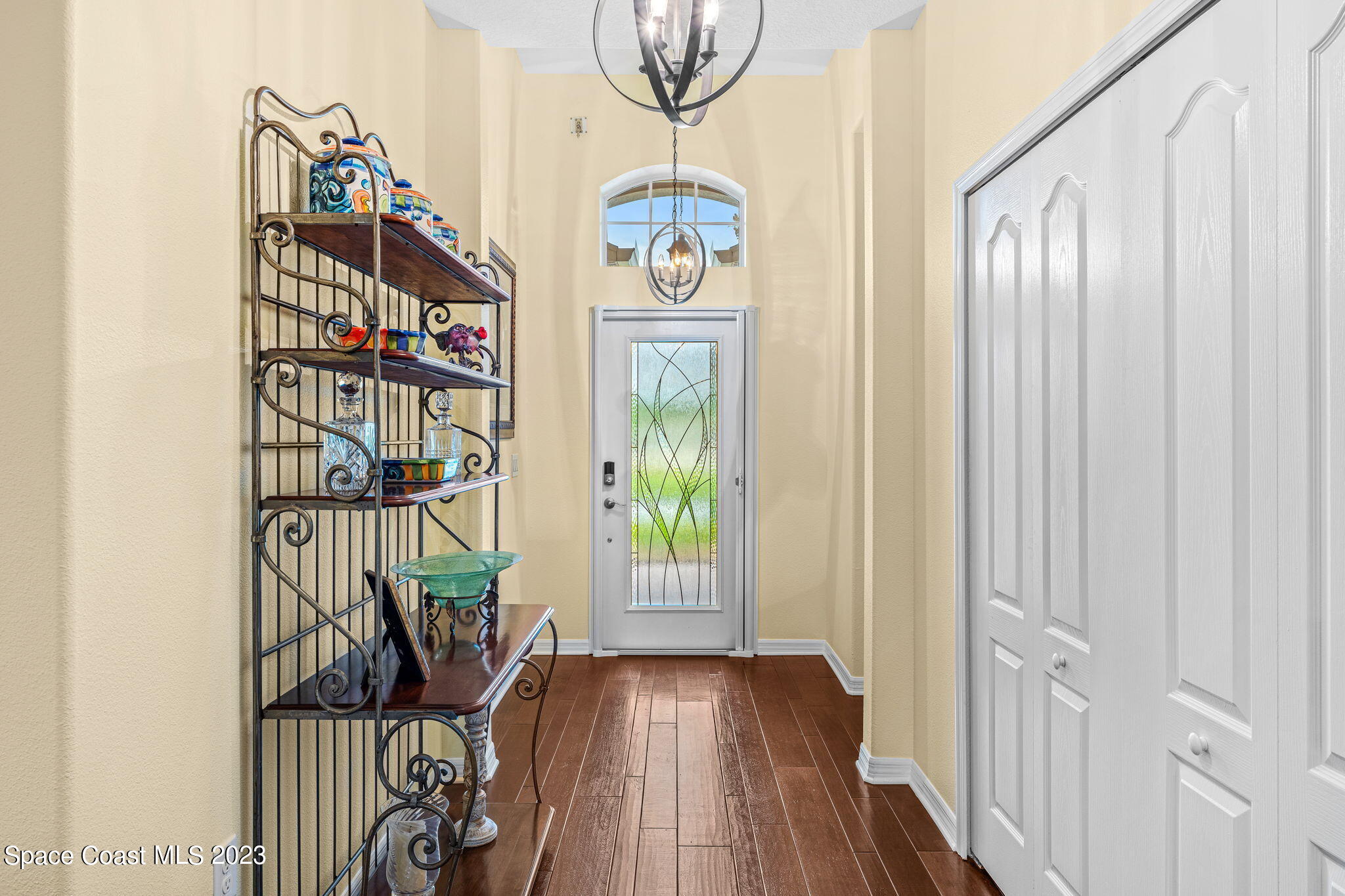 3428 Ahern Place Melbourne, FL 32940 - Photo 6 of 64 a view of front door with wooden floor