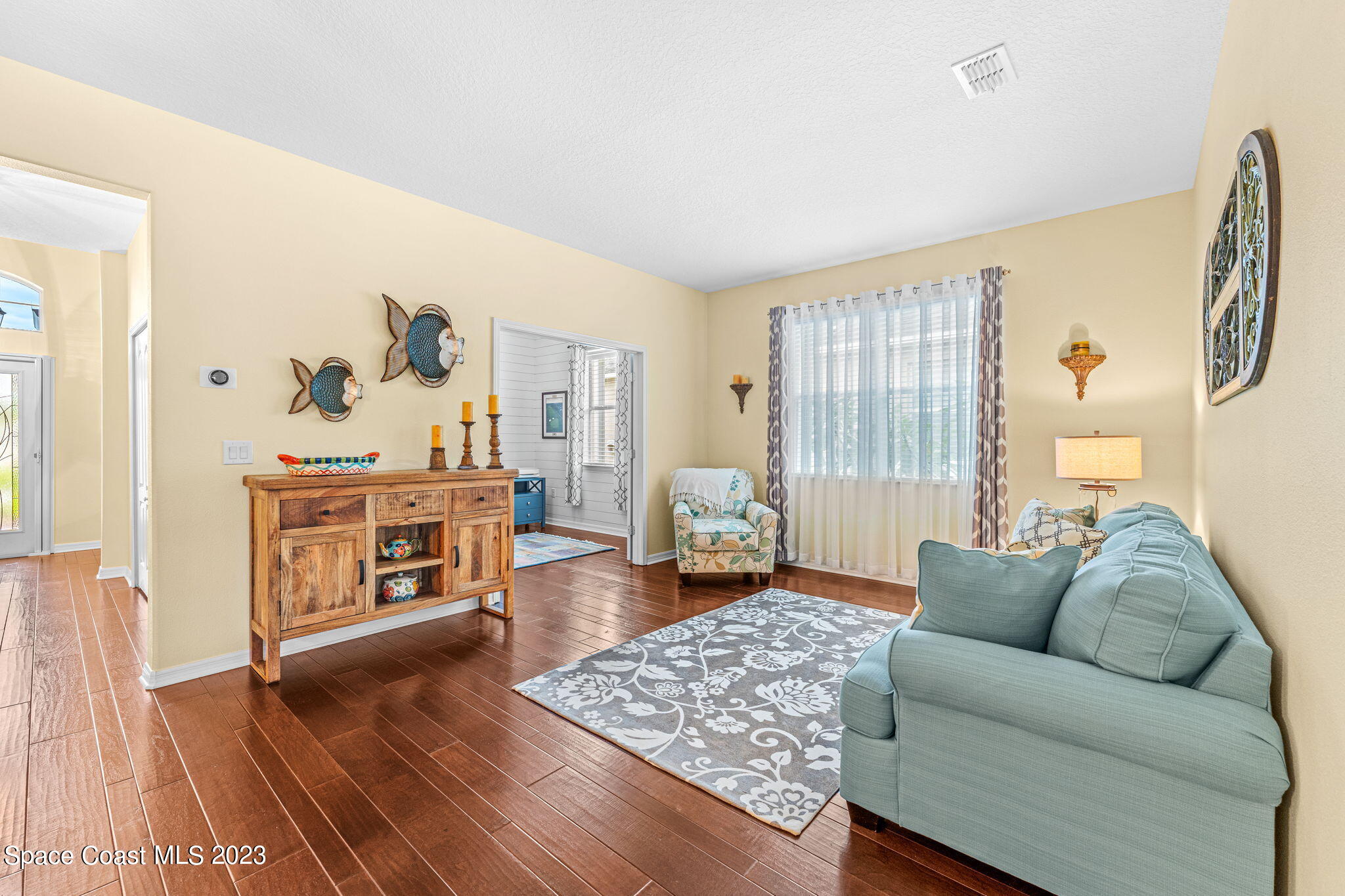 3428 Ahern Place Melbourne, FL 32940 - Photo 7 of 64 a living room with furniture and wooden floor