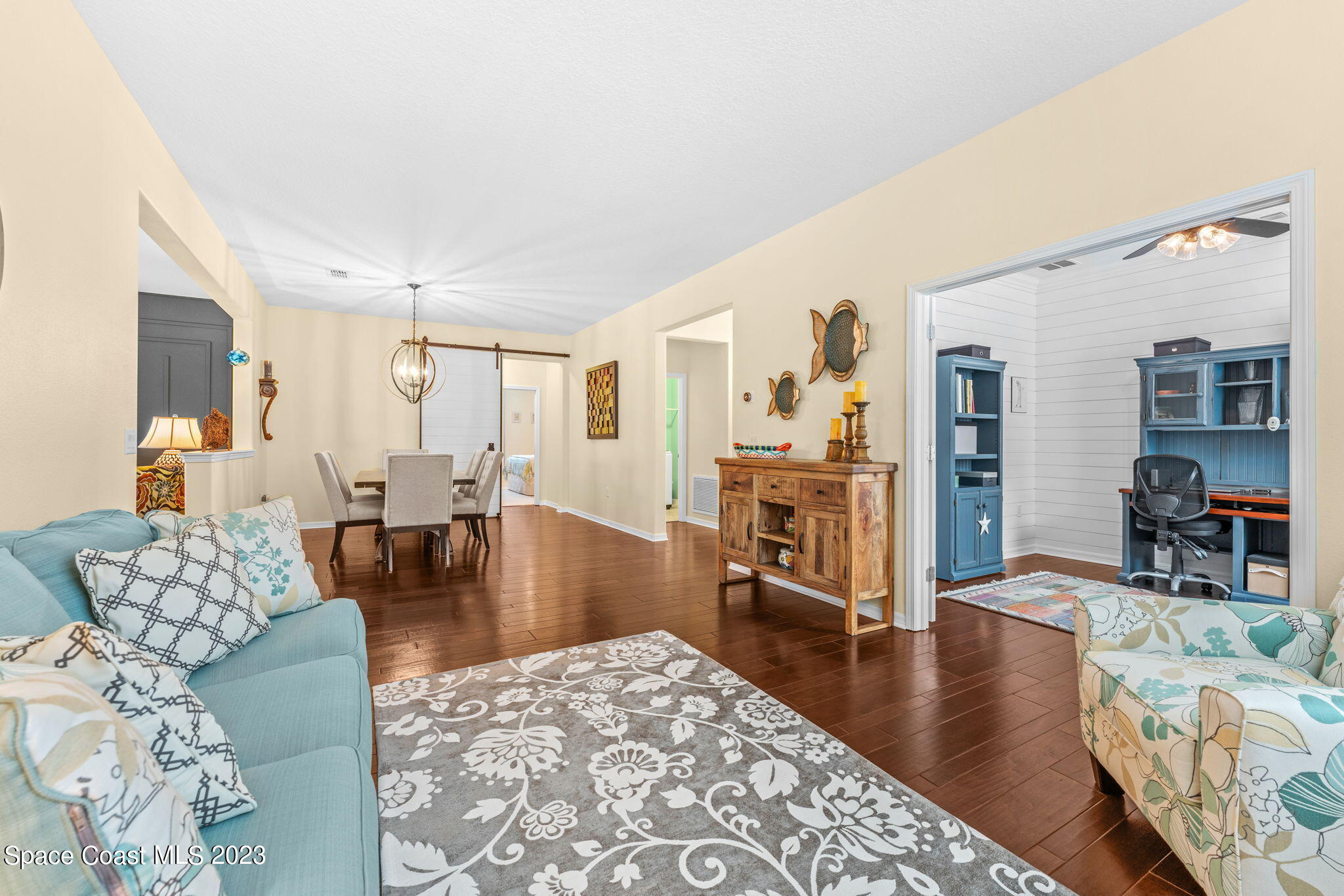 3428 Ahern Place Melbourne, FL 32940 - Photo 8 of 64 a living room with furniture and a wooden floor