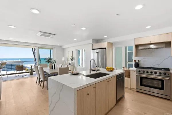 a kitchen with a stove a sink and a refrigerator