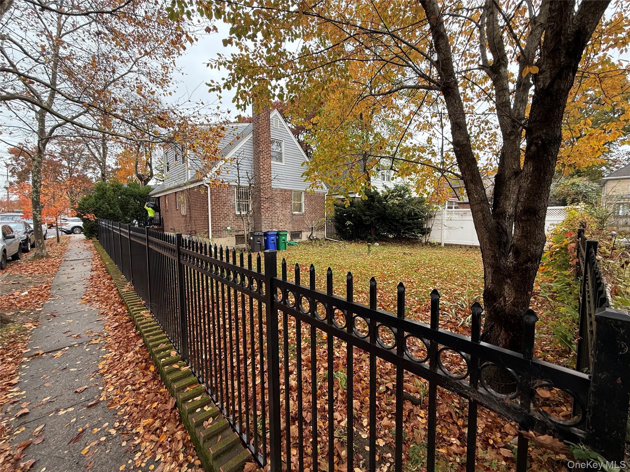 a view of house with outdoor seating and trees