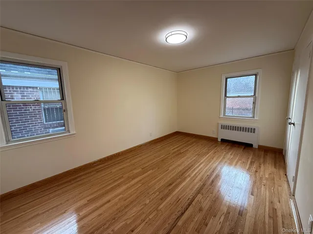 a view of a room with wooden floor and window