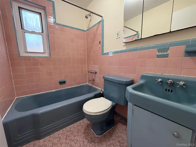 a bathroom with a sink a toilet and bathtub