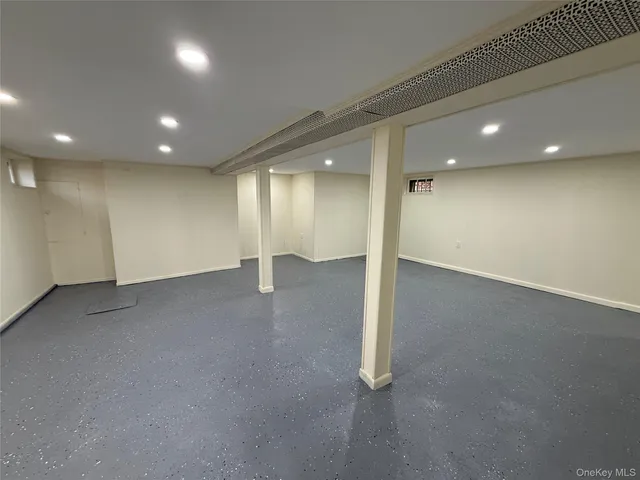 an empty room with a projector and screen