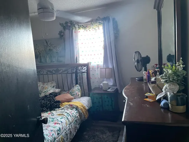 a bedroom with furniture and a large window