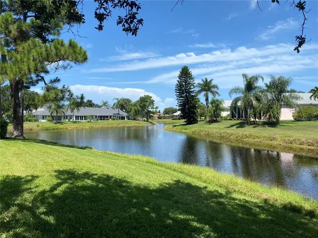a view of a lake with houses in the background