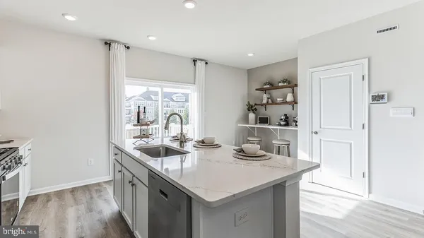 a kitchen with granite countertop a sink and cabinets