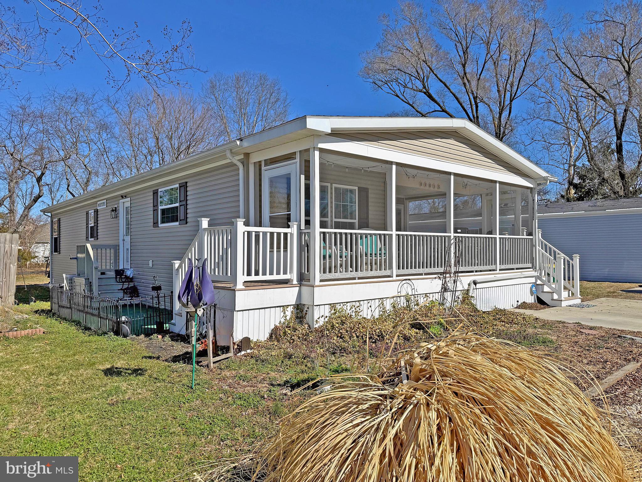31655 Janice Road, Unit A36 Lewes, DE 19958 - Photo 1 of 32 a front view of a house with a yard