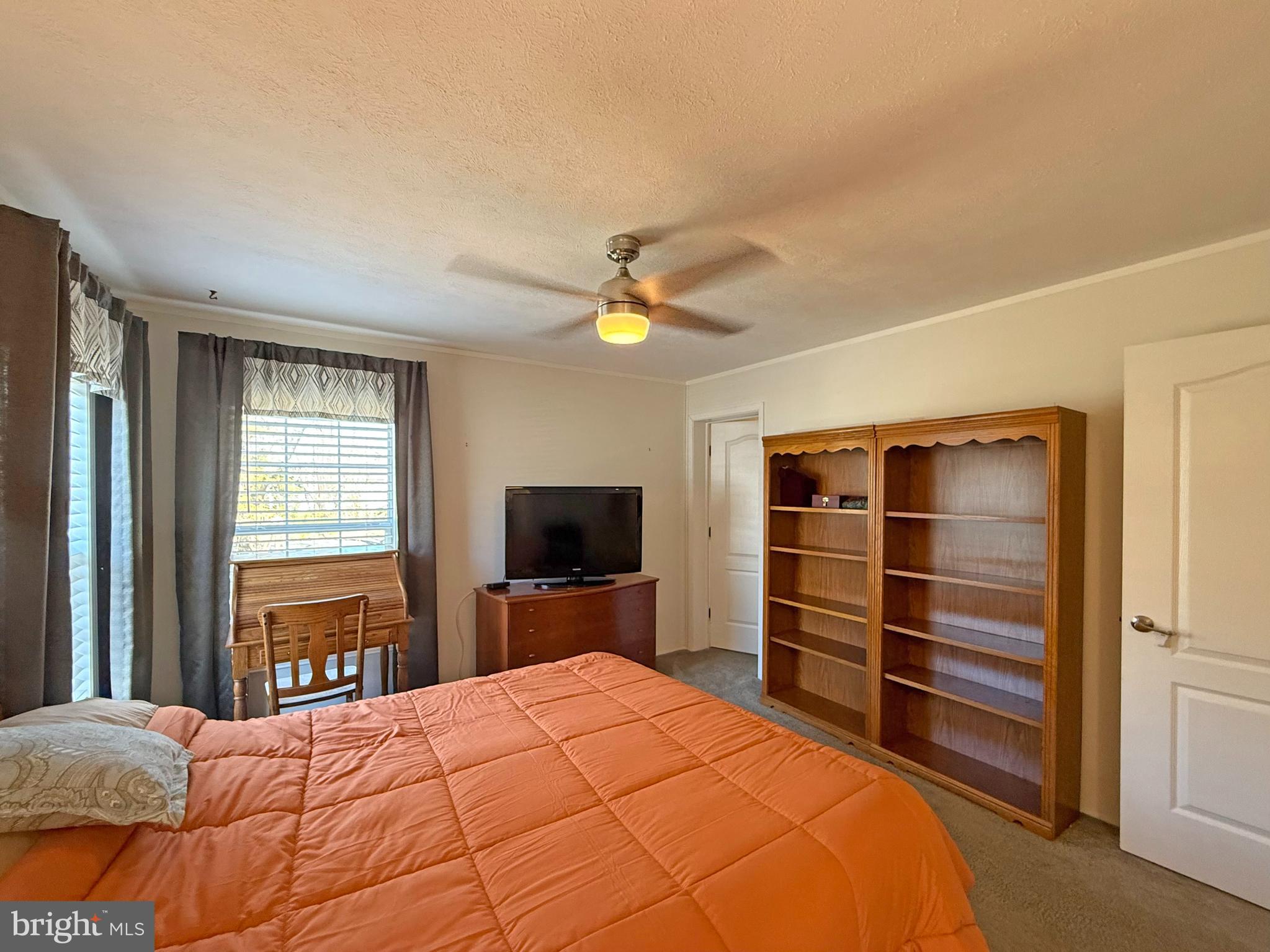 31655 Janice Road, Unit A36 Lewes, DE 19958 - Photo 12 of 32 a bedroom with a bed and a television