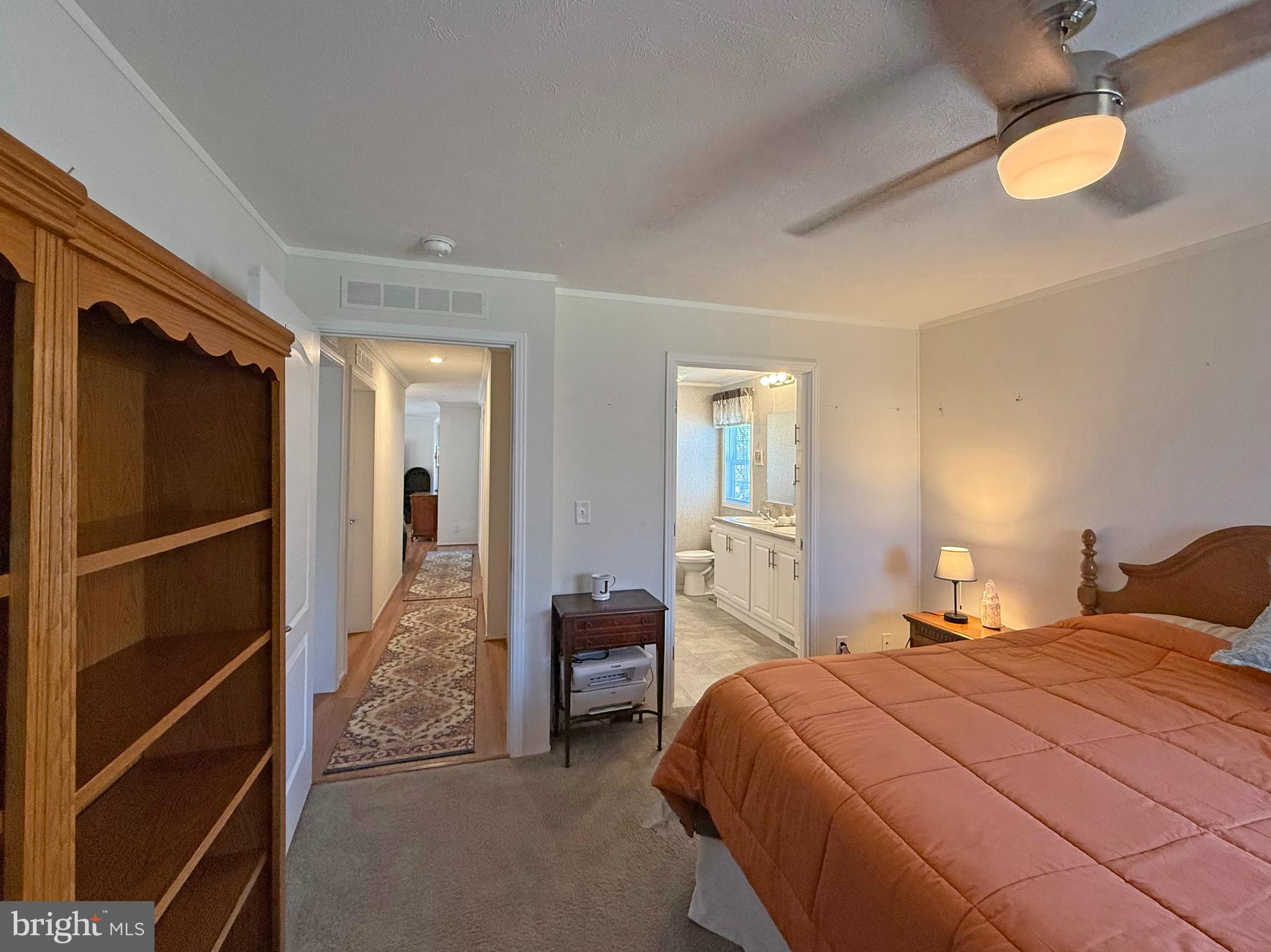 31655 Janice Road, Unit A36 Lewes, DE 19958 - Photo 13 of 32 a bedroom with a bed and a walk in closet