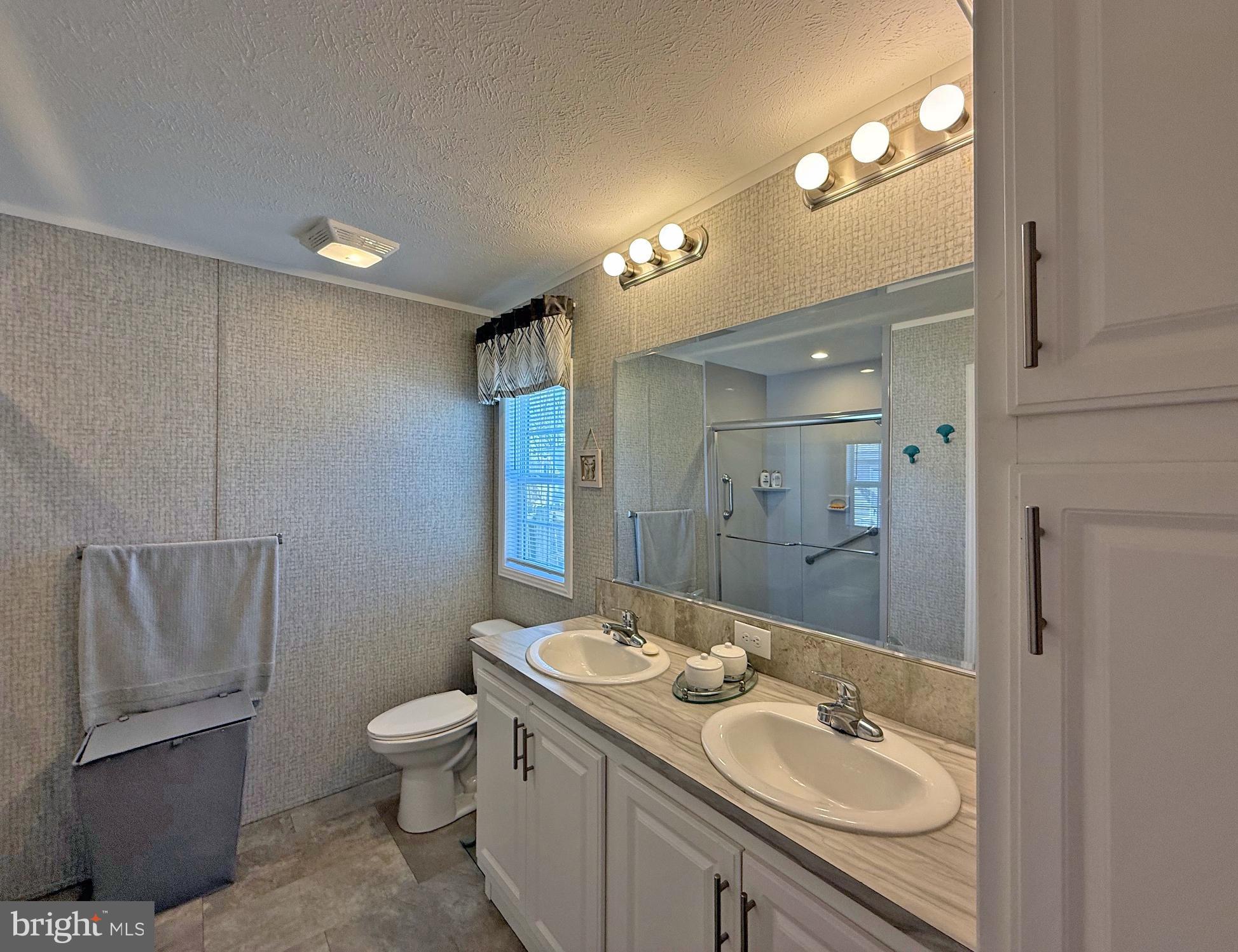 31655 Janice Road, Unit A36 Lewes, DE 19958 - Photo 14 of 32 a bathroom with a toilet sink and mirror