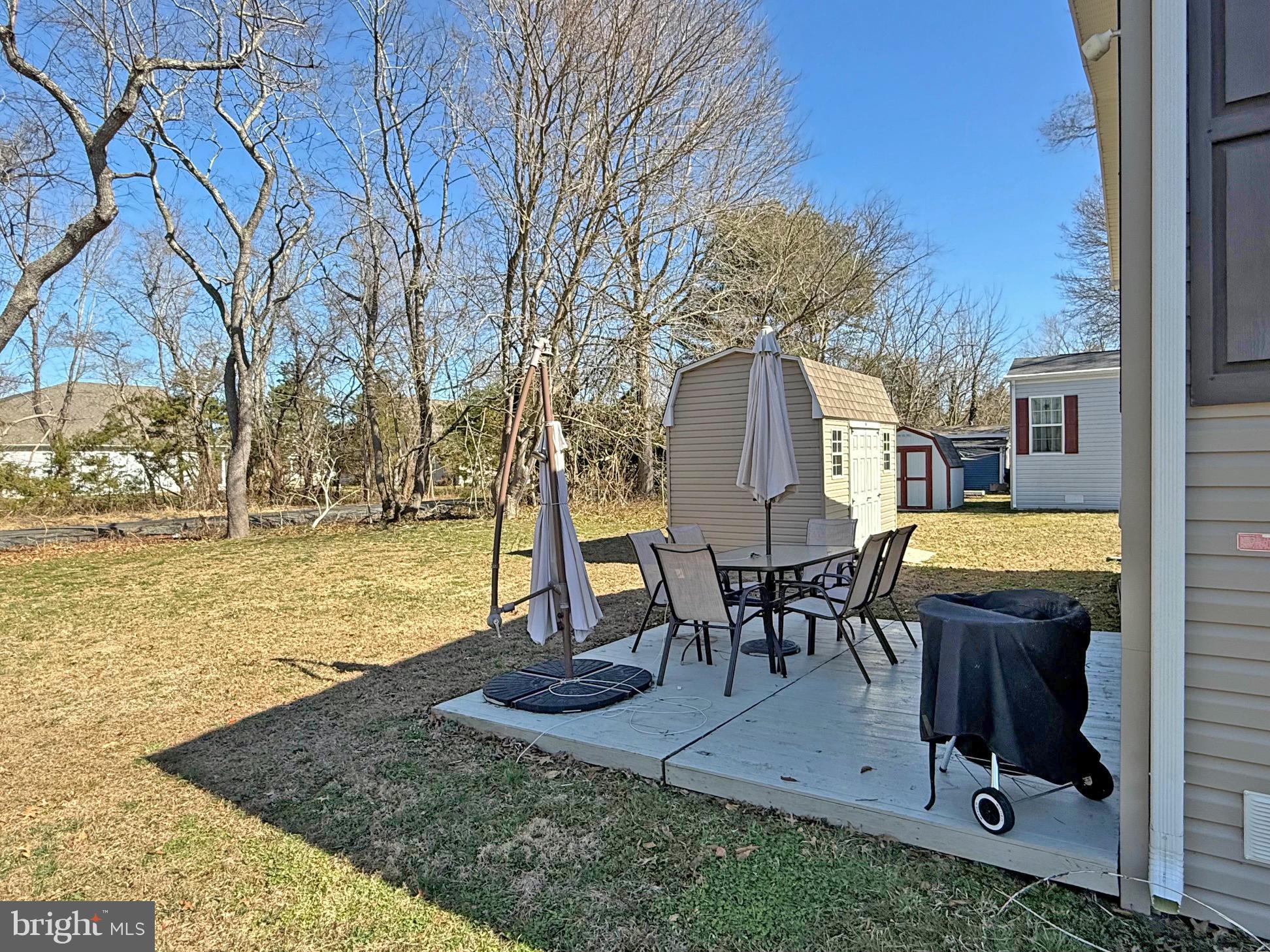 31655 Janice Road, Unit A36 Lewes, DE 19958 - Photo 27 of 32 a view of a backyard with fountain table and chairs