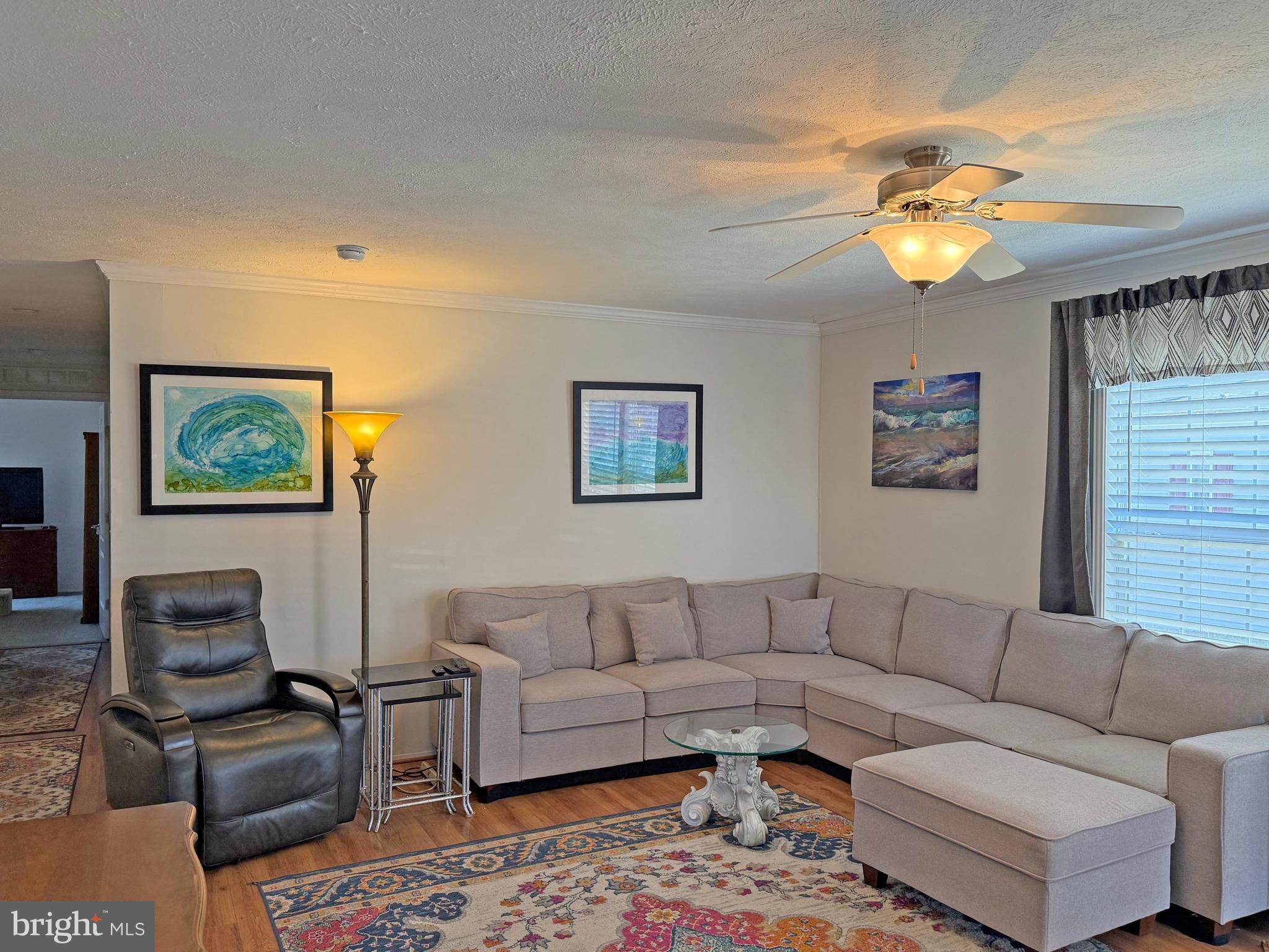 31655 Janice Road, Unit A36 Lewes, DE 19958 - Photo 4 of 32 a living room with furniture a chandelier and a window