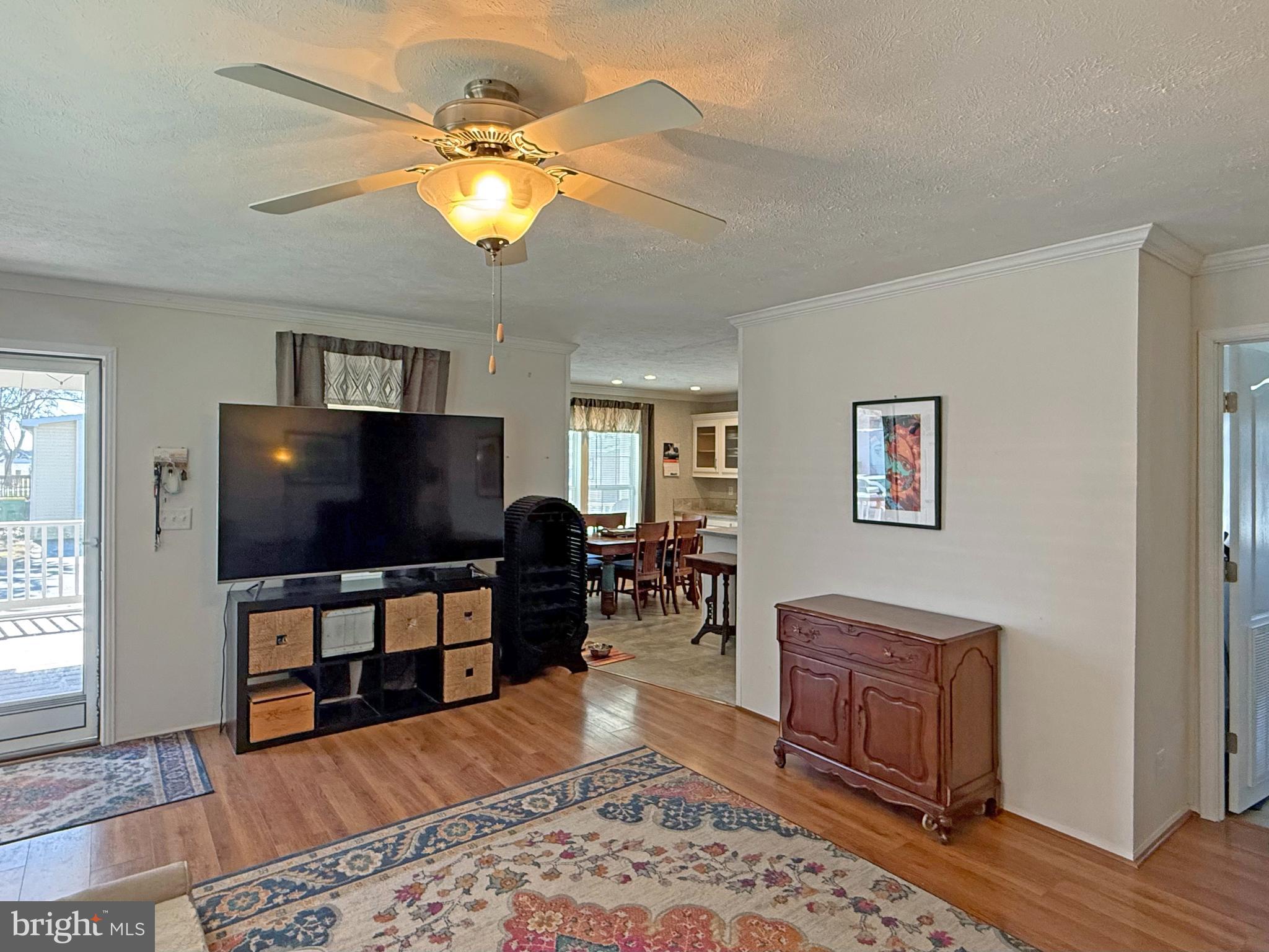31655 Janice Road, Unit A36 Lewes, DE 19958 - Photo 6 of 32 a living room with furniture and a flat screen tv