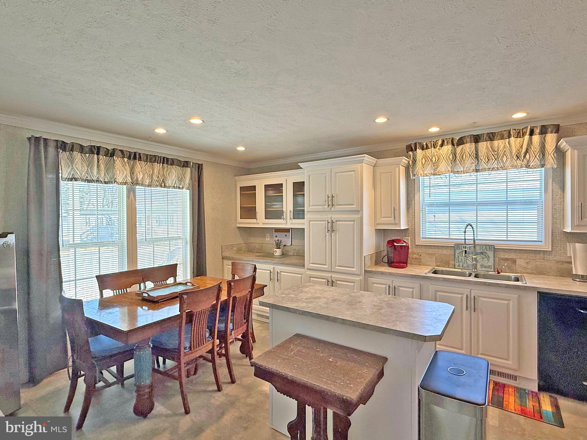 31655 Janice Road, Unit A36 Lewes, DE 19958 - Photo 7 of 32 a view of a dining room with furniture and a large window
