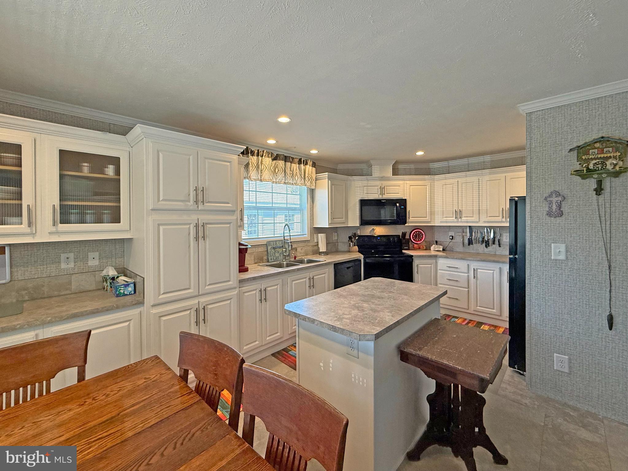 31655 Janice Road, Unit A36 Lewes, DE 19958 - Photo 8 of 32 a kitchen with a refrigerator a sink and cabinets